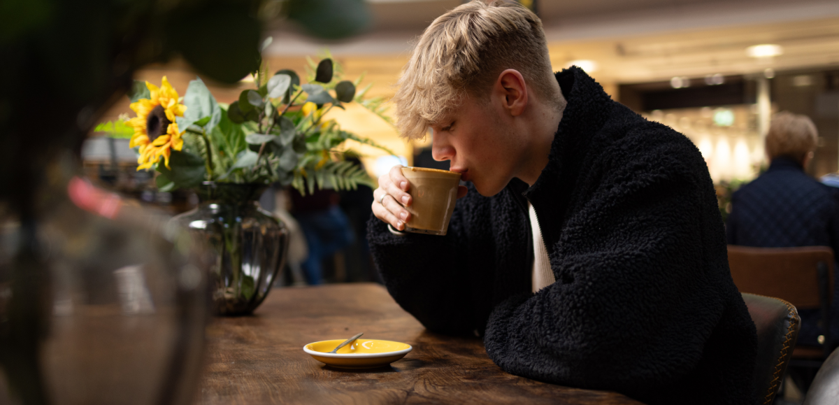 Person sipping coffee Mettricks Westquay