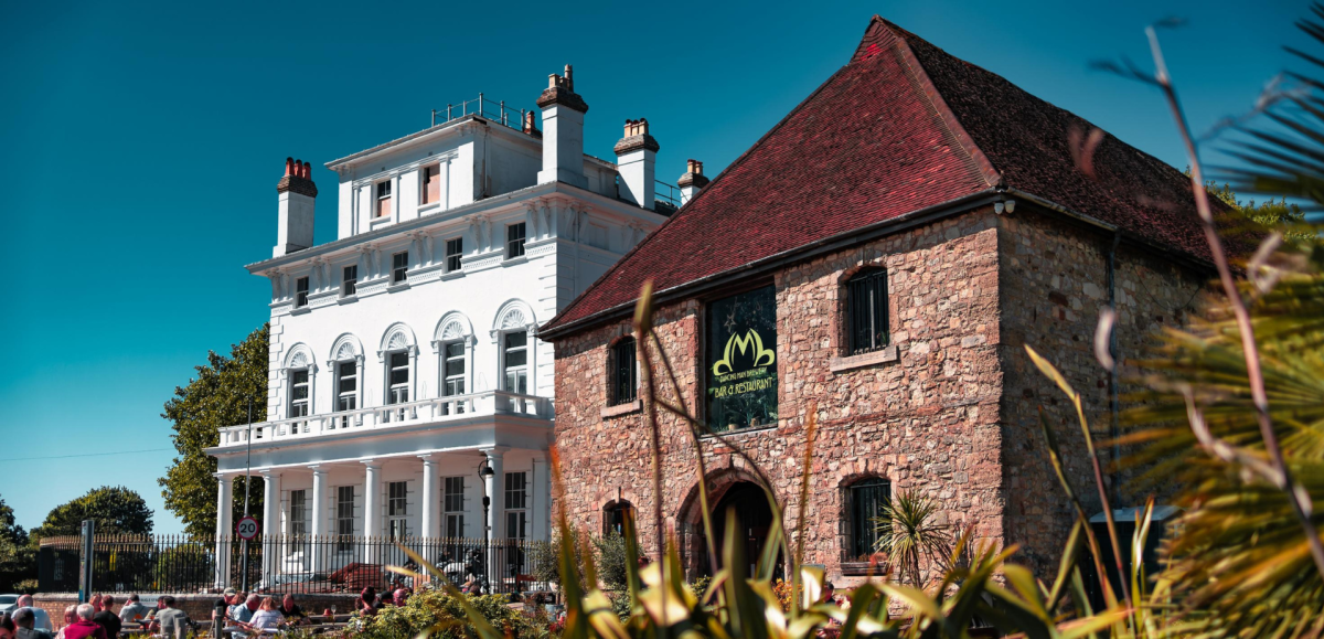 Exterior shot of Dancing Man Brewery building and white building next to it
