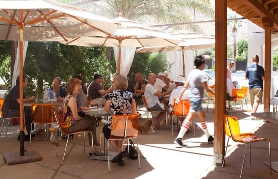People eating at the outdoor patio at Cheeky's in Palm Springs