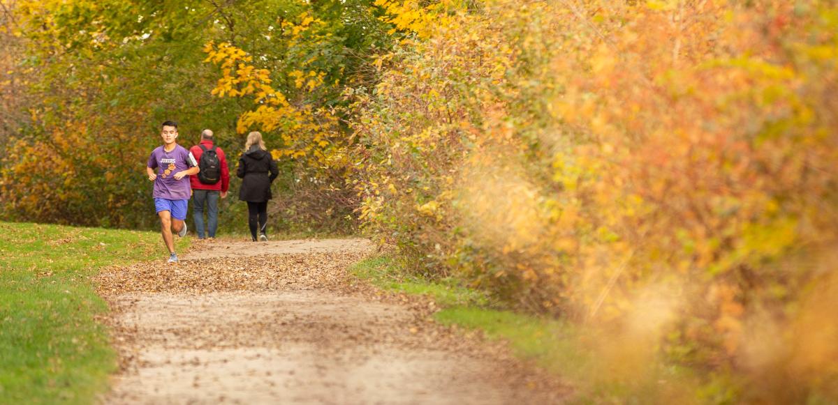 A man runs on the Lakeshore Path in fall