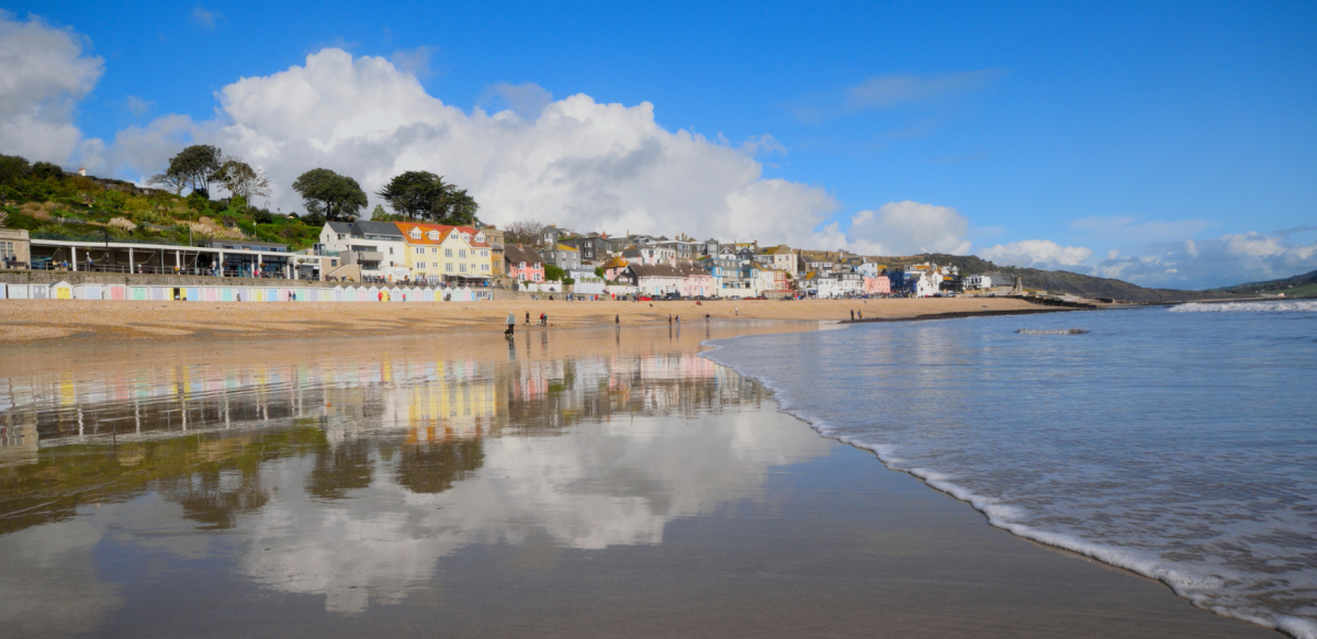 Lyme Regis beach reflections in the water