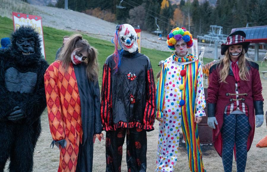a group of spooky lift ride workers including a gorilla, harley quinn, 2 scary clowns and a spooky ringmaster