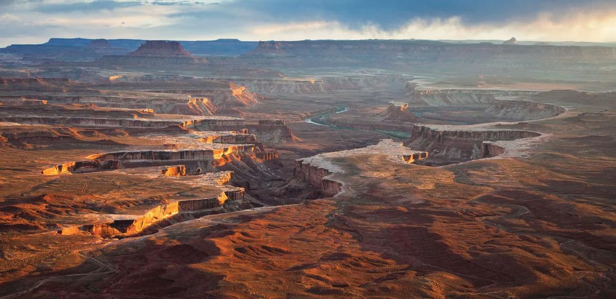 Canyonlands National Park in southeastern Utah captures the dramatic layers of red rock canyons carved by the Green River.