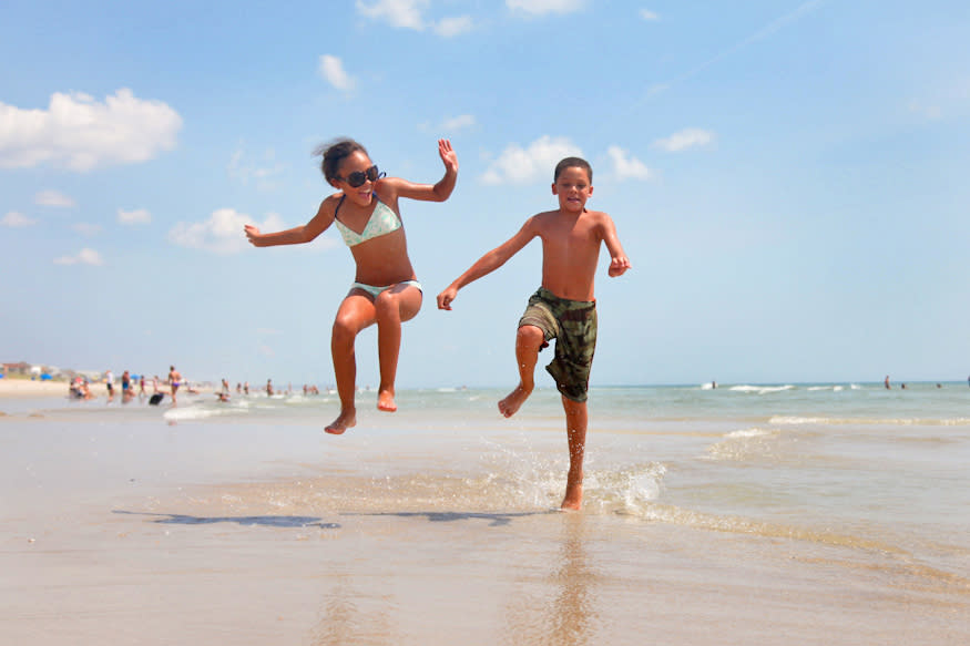 Kids jumping on the beach