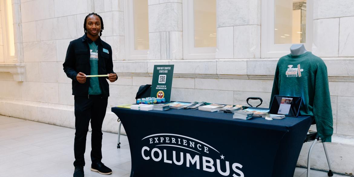 Team member working Experience Columbus booth during event