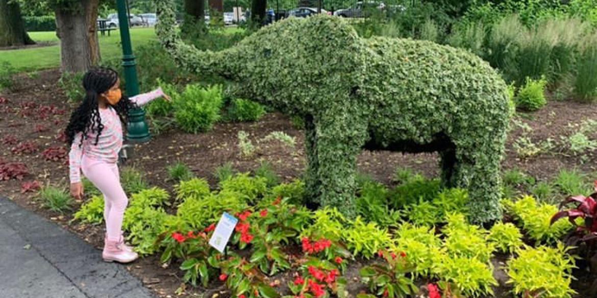 Little girl enjoying a topiary at Franklin Park Conservatory