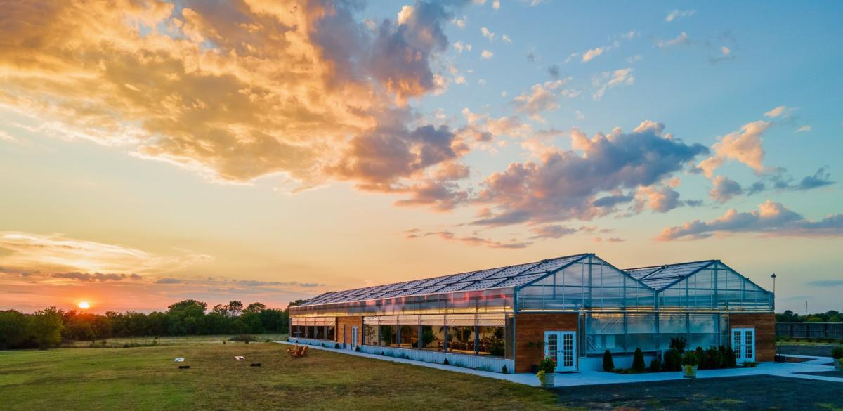 The double greenhouse Atreeum Greenhouse venue is photographed at sunset