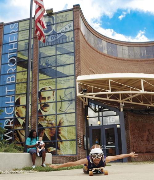 Child Pretending to Fly in front of Dayton Aviation Heritage National Historical Park