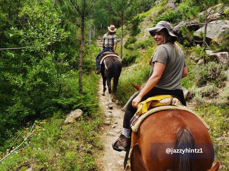 People horseback riding inside Rocky Mountain National Park