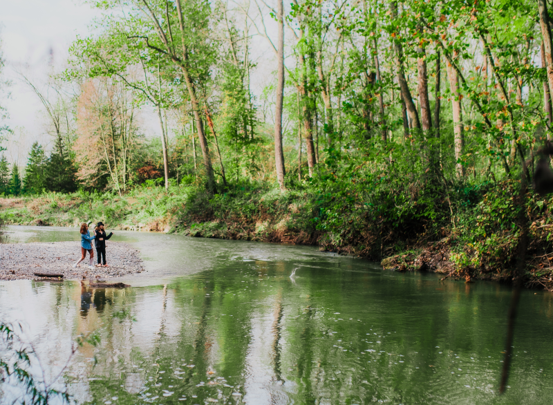 Two women by water in park