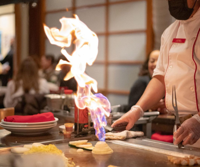 Fire coming out of a stack of onion rings during a table side cooking experience