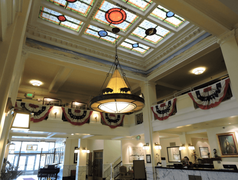 Elegant lobby of the Historic Plains Hotel with patriotic bunting, ideal for a romantic stay in Cheyenne.
