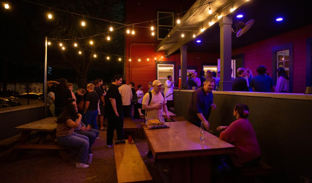 Outdoor patio at ColdeTowne Theater illuminated by string lights.