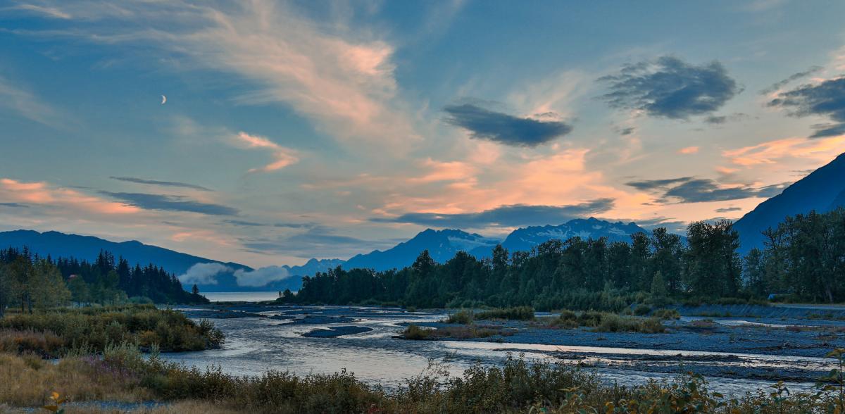 The lower part of a glacier-fed creek flows into a bay