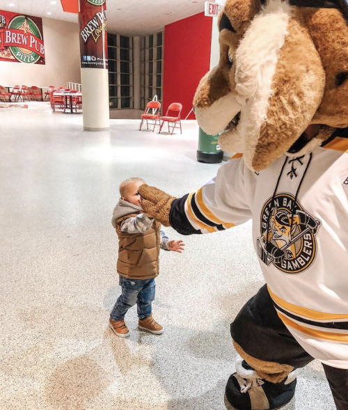 Child High fiving gamblers mascot