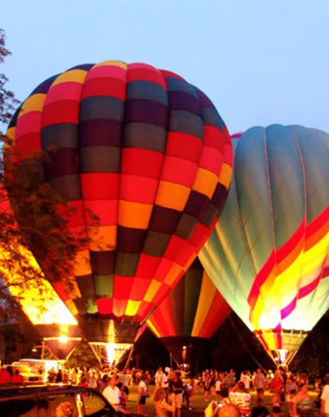 Multi colored hot air balloons glowing with light at Coney Island