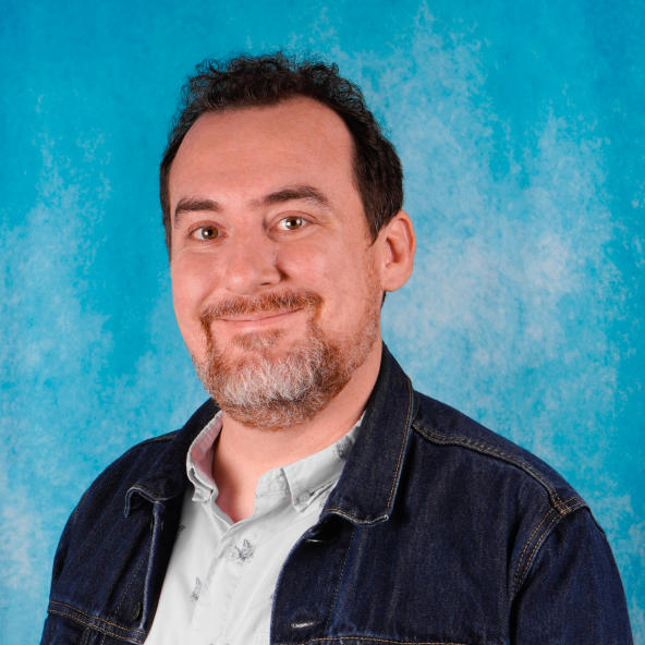 Headshot shows man smiling at the camera