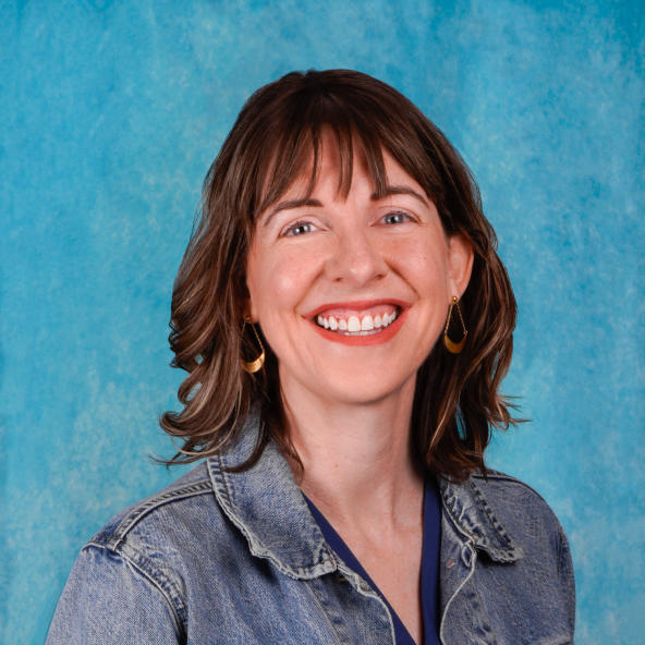 Woman's headshot with a blue background.