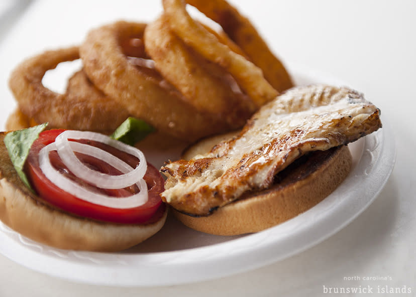 A fresh sandwich paired with onion rings from a local eatery makes perfect picnic fare.