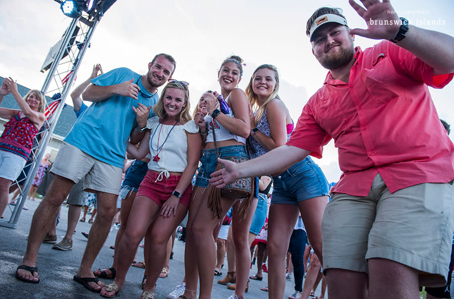 a group of people pose for a camera at the NC 4th of July Festival in Southport, NC