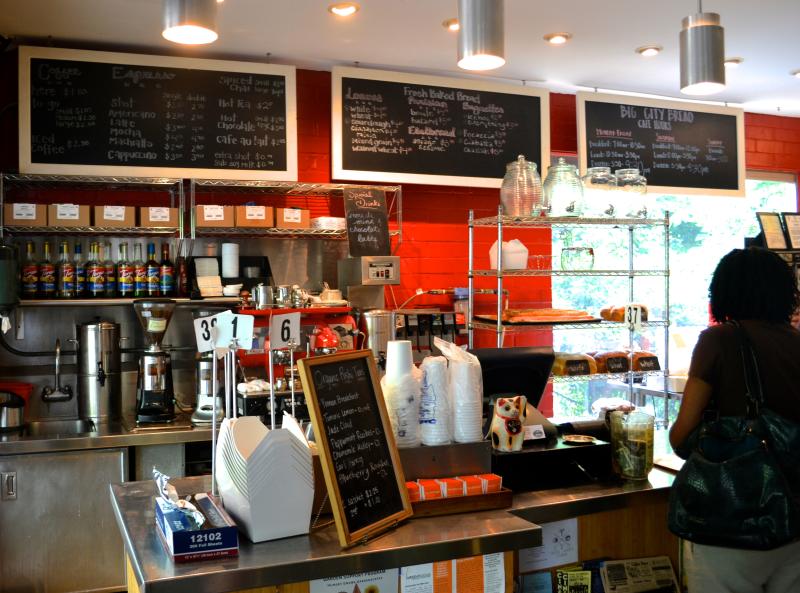 A woman ordering at a cafe counter