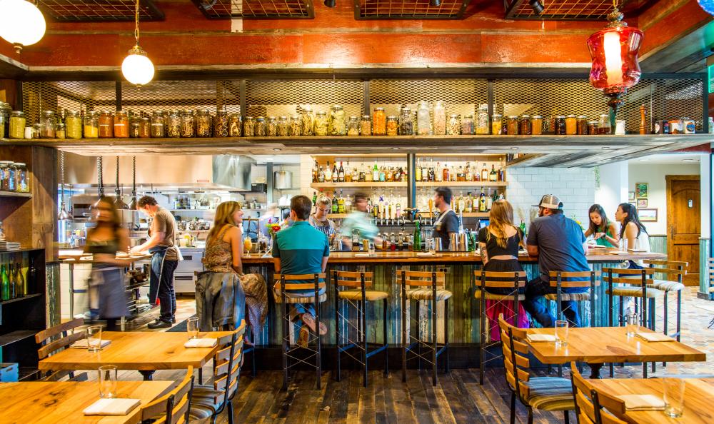 People dining at the bar at Barley Swine in Austin Texas