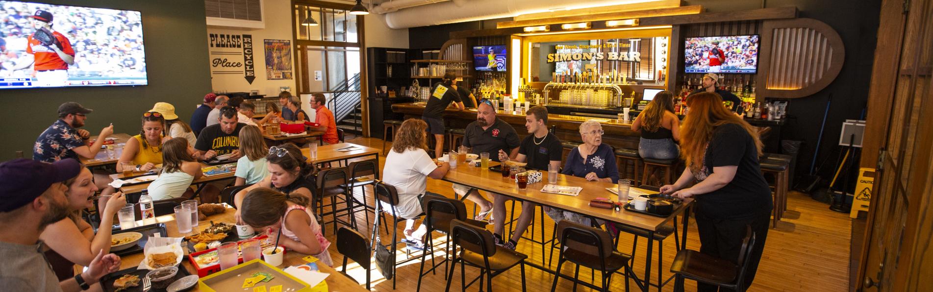 Guests enjoying food, drinks and games at Simon's Bar in Budd Dairy Food Hall