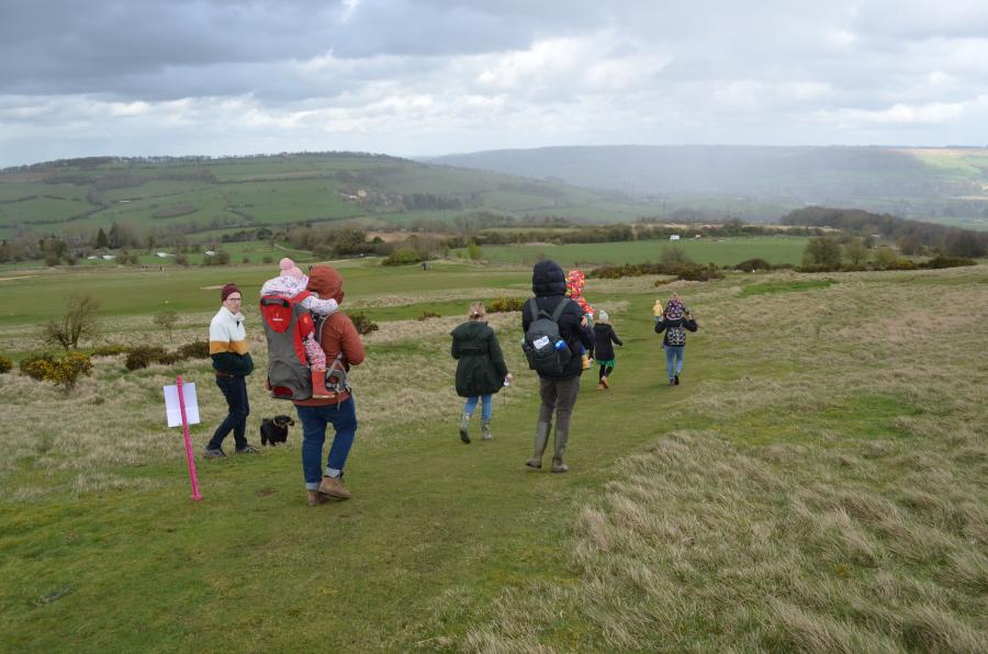 A group of families and dog walking on Cleeve Common