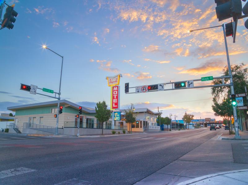 Street view of the Imperial Inn (formerly the Imperial 400) with its restored sign lit up, on Central Avenue.