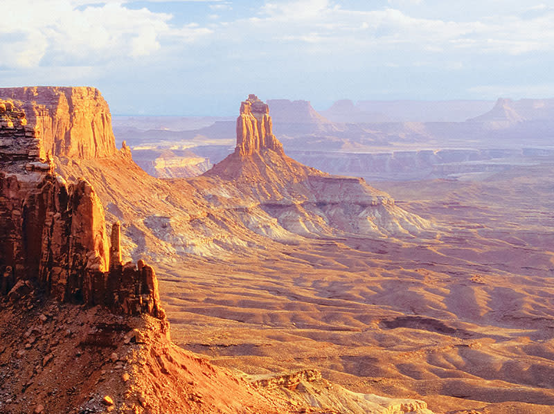 Sunset at Candlestick Tower, a prominent sandstone spire located in the Island in the Sky district of Canyonlands National Park in Utah.