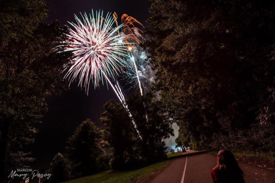 Fireworks on rural road through trees