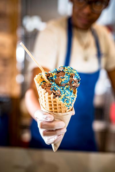 Ice cream and sprinkles served up in a fresh waffle cone from UDairy,