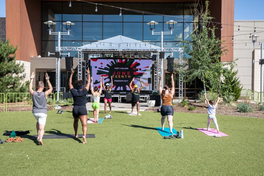 People do yoga at the Juneteenth event at Foothills Mall