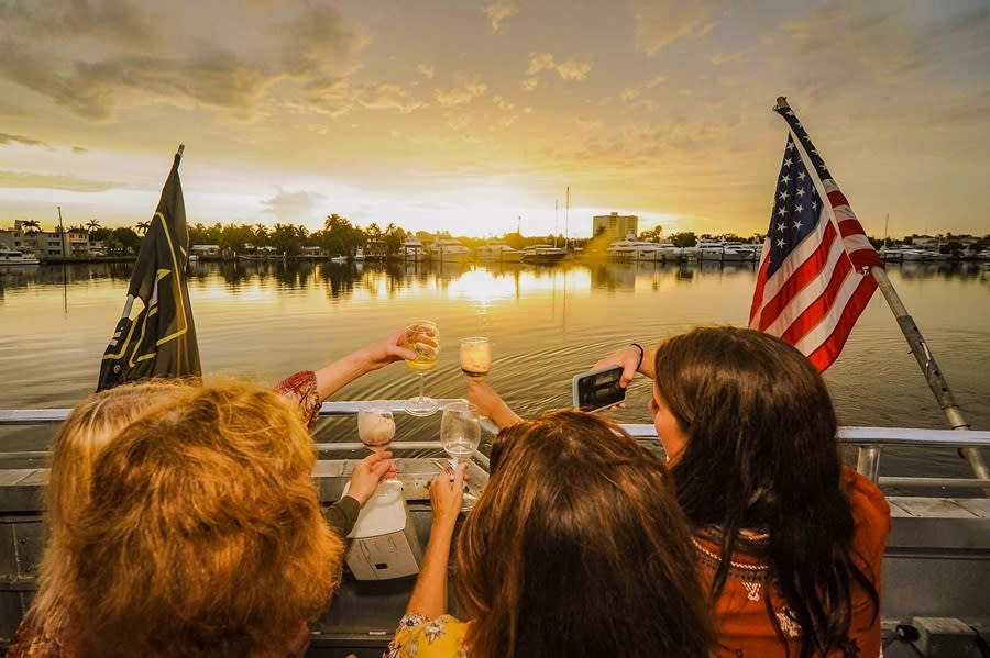 Four girlfriends, capturing an image of them making a toast on board the Water Taxi at Sunset