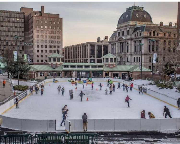 People ice skating at the Providence Rink on a winter day.