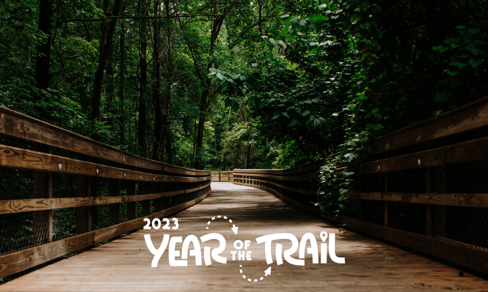 Year of Trail log on Clayton greenway photo.