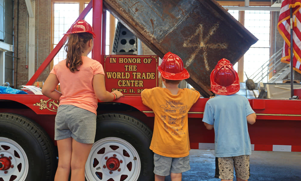 Kids standing at 9/11 exhibit at Fire Truck Festival