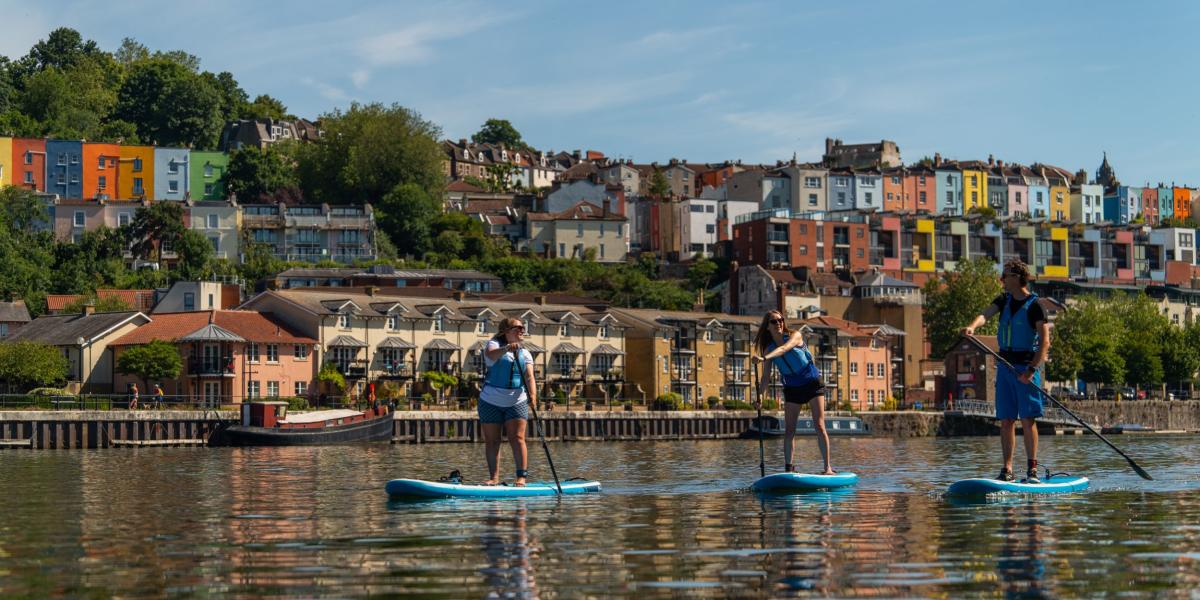 Paddleboarders in front of Hotwells on Bristol Harbourside - credit Visit West