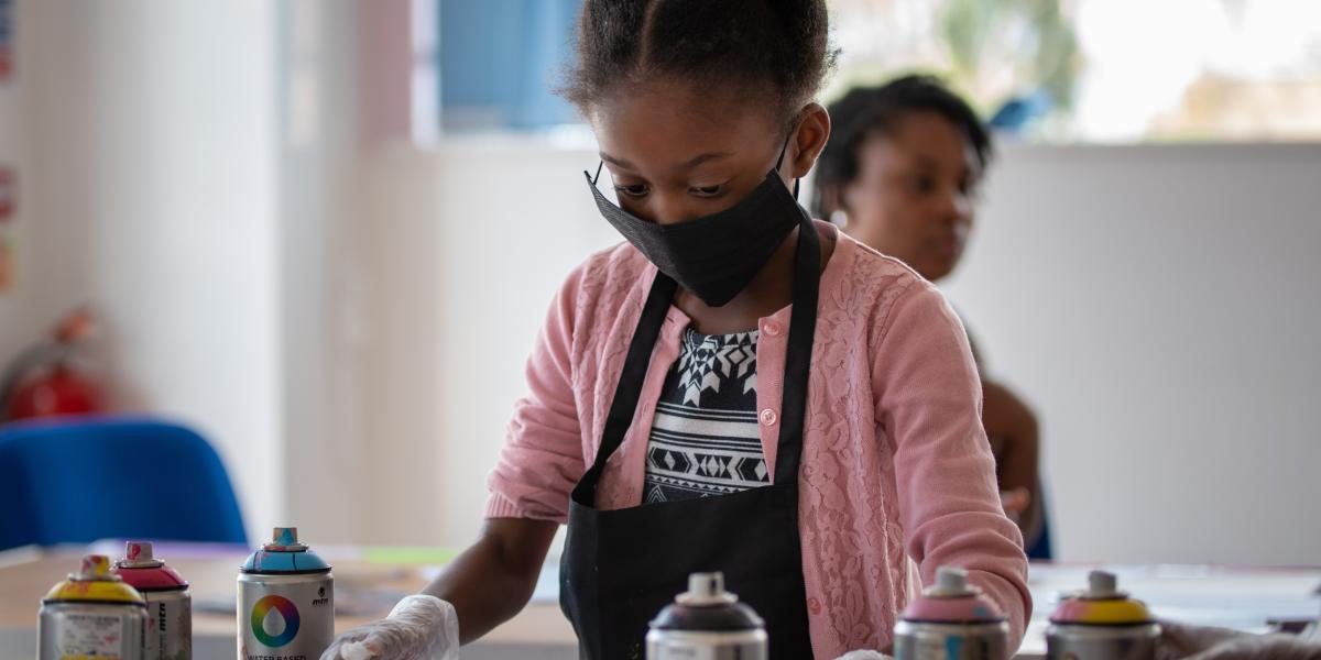 A young girl taking part in one of the street art workshops at Graft Bristol - credit Graft