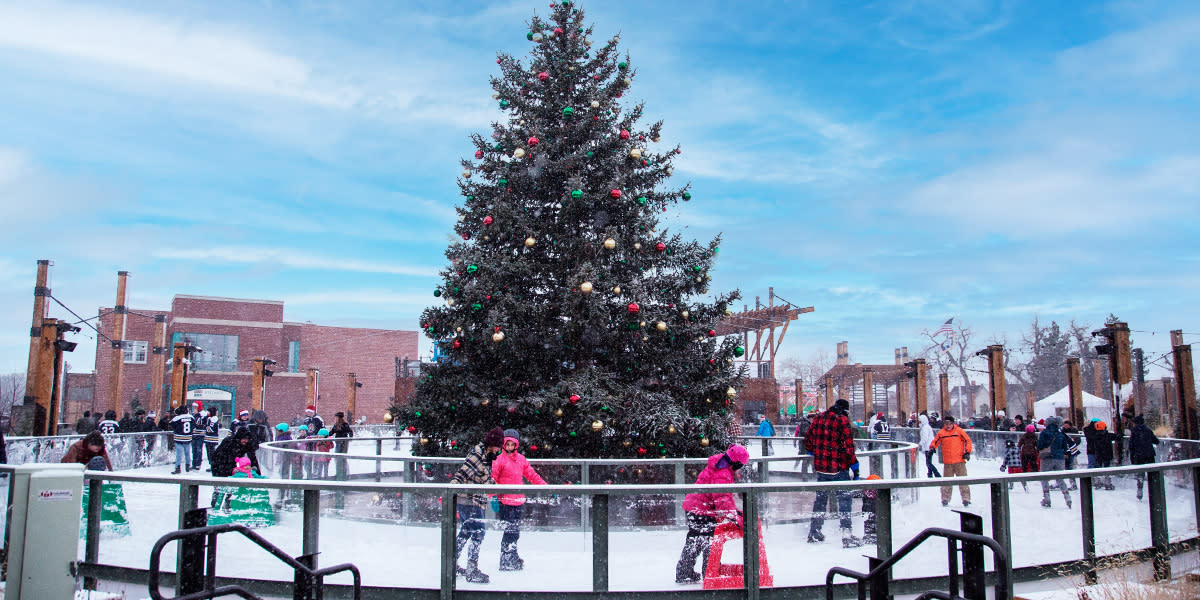 Outdoor ice skating around a pine tree with ornaments in downtown Casper, WY