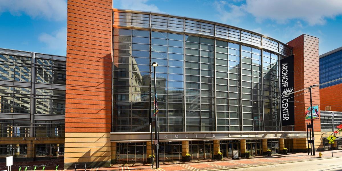 Image is of the outside of the Aronoff Center during the daytime from the front.