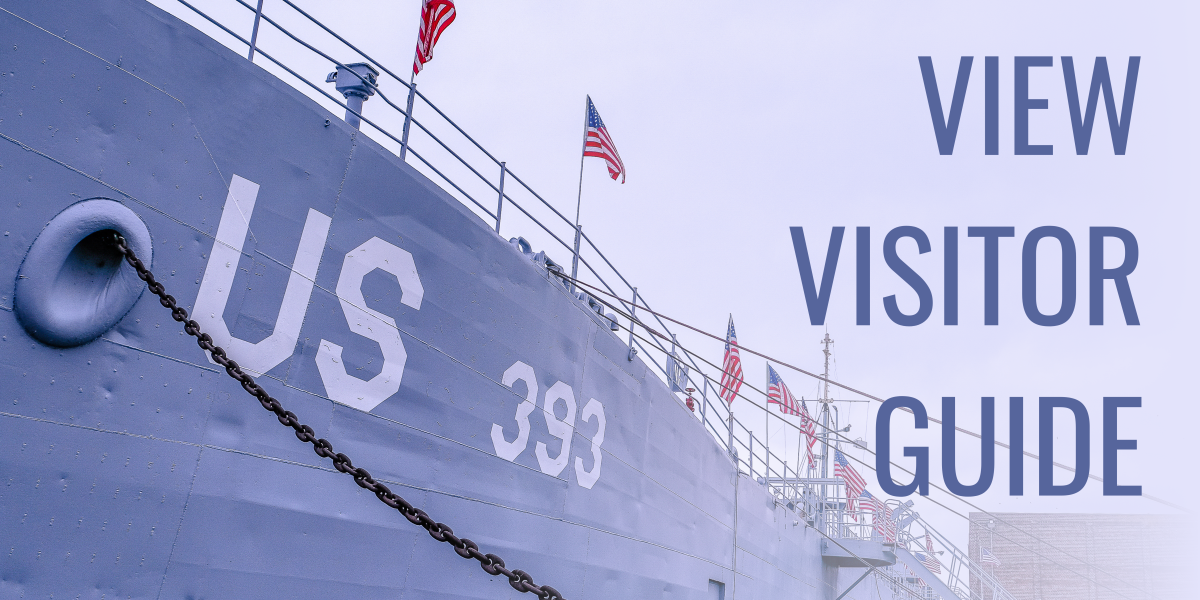 Photo of bow of uss lst 393 museum ship with text on right that reads VIEW VISITOR GUIDE
