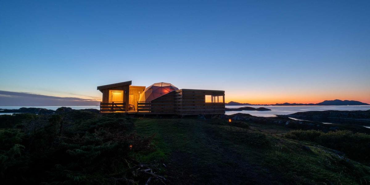 Sun low on the horizon at glamping accommodation in Bergen, Norway