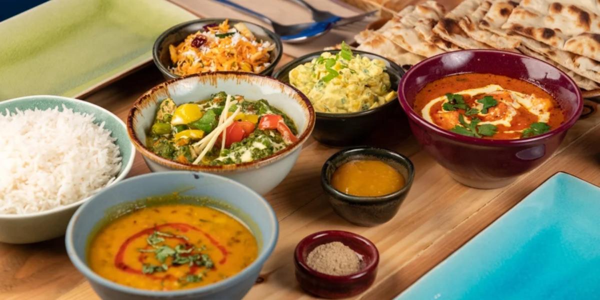 spread of veggie dishes Baboo Ji on wooden table