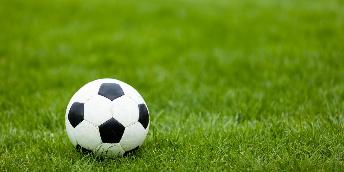 Football on green grassy field