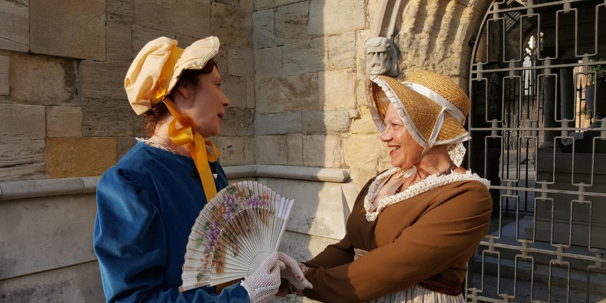 Two women dressed up as Jane Austen