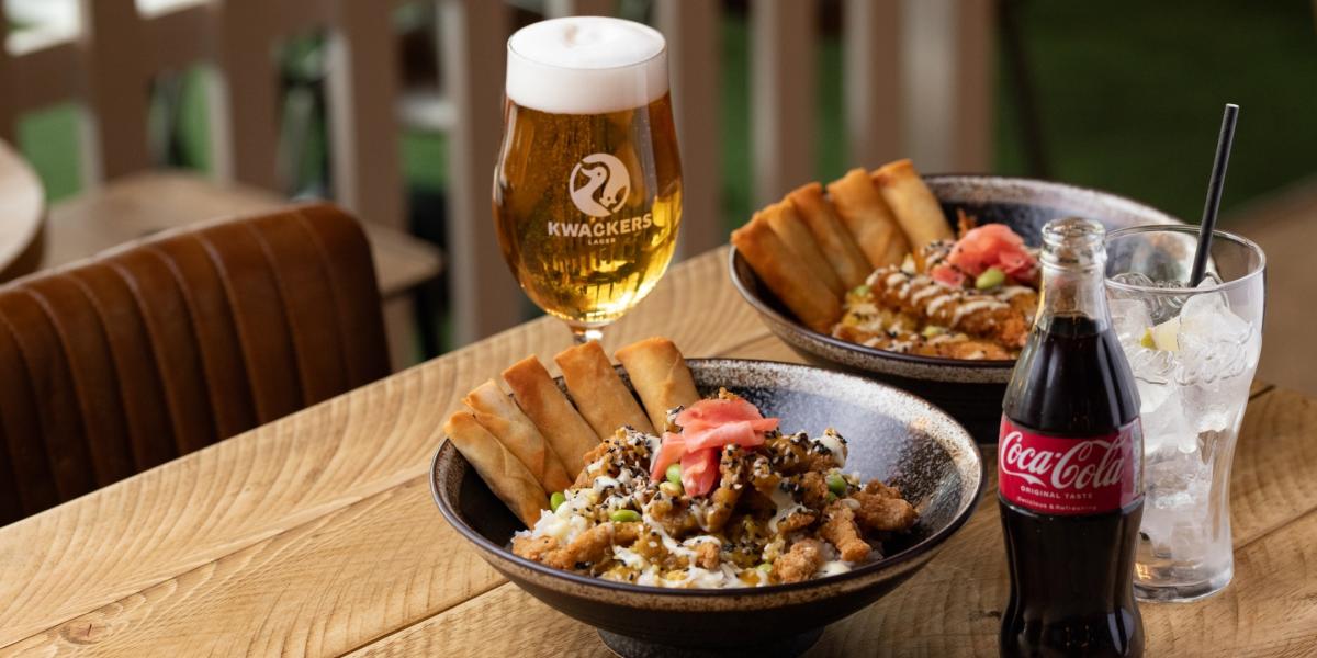 Kwackers katsu curries with spring rolls, draft beer and a glass of coca cola
