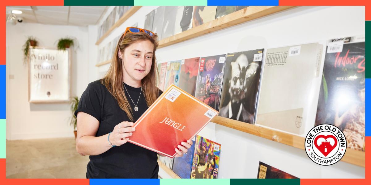 Woman looking at vinyl record in Vinilo Record Store