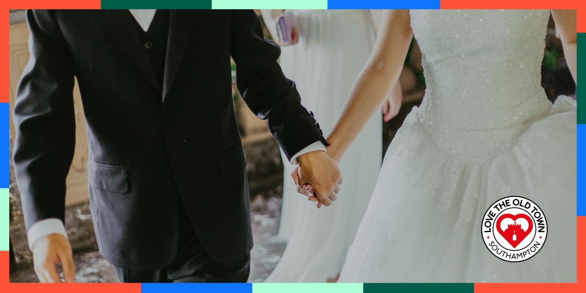 Bride and groom holding hands as they walk down the aisle