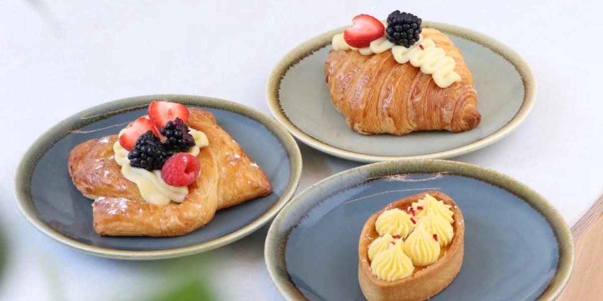Nami Bakehouse Pastries including croissants topped with fresh cream and berries